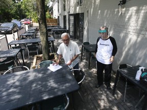 Stratengers Restaurant and Bar owners Dharam Vijh, left, and his brother, Anil, prepare their patio for eventual reopening on Thursday, June 4, 2020 in Leslieville.