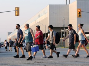 Into the morning light, autoworkers leave FCA's Windsor Assembly Plant following the final third shift at 7 a.m. Friday. Moving forward the plant, which produces Chrysler Pacificas and Dodge Grand Caravans will operate on two shifts.