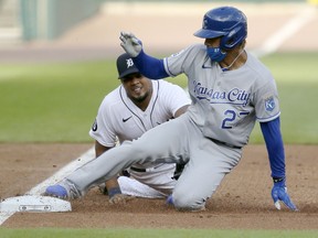 Adalberto Mondesi of the Kansas City Royals beats the tag from third baseman Jeimer Candelario of the Detroit Tigers for a triple during the second inning at Comerica Park on July 29, 2020, in Detroit, Michigan.