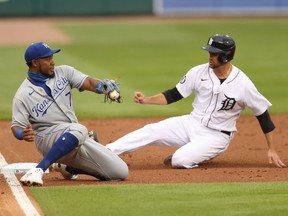 Jordy Mercer of the Detroit Tigers slides past Maikel Franco of the Kansas City Royals in the second inning during the home opener at Comerica Park on July 27, 2020 in Detroit, Michigan.