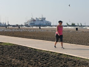 Elizabeth Toplis walks on the boardwalk at Leamington's Seacliff Park Sunday. Leamington is moving forward on a project to develop its waterfront as a destination. Called the Waterfront Destination Master Plan; it is expected to guide the transformation of the waterfront into an area focused on the pedestrian community and also working to make it a visitor destination.
