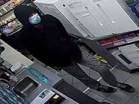 Windsor police have released surveillance photos of a man who robbed a store on July 1, 2020, while wearing a surgical mask.