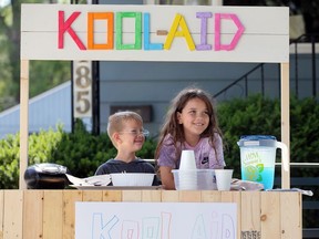 Kool-Aid kids Leah Laliberte, 8, and her brother Alex Laliberte, 5, left, chat with a customer on Francois Road Wednesday.  Leah raised nearly $150 for The Hospice.