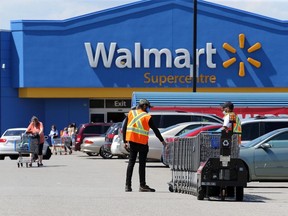 Windsor, Ontario. July 24, 2020.  Walmart workers collect shopping carts at the South Windsor Walmart on Dougall Road.