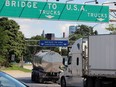 Truck traffic flows toward the Ambassador Bridge, the international border crossing from Windsor, Ontairo to Detroit, Michigan.