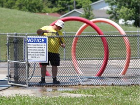 A worker using a power washer attached to a DBi Services truck cleans the splash pad at Constable John Atkinson Community Centre on Monday, July 6, 2020. Windsor hopes to open up splash pads soon to help keep area residents cooler during hot weather.
