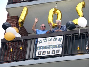 Harry Arpan, right, and his son, Jim Arpan, wave to family, friends and neighbours after they sang Happy Birthday on Saturday to the Canadian Army veteran who turned 102 years old.  While Harry Arpan was with the West Nova Scotia Regiment, he was seriously wounded twice in battle. He rarely talks about his incredible days on the battlefield in Italy.