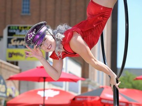 Aerial artist Alex Urbano dressed in captain's hat and costume salutes a small crowd near Grill 20 on University Avenue East Saturday, July 25, 2020, during a downtown open-streets event.