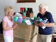 "What we do is crucial." Kim Spirou and Mike Rovers of Second Chance Ministry sort through food and dry goods on July 25, 2020, destined for people in need.