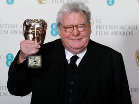 Alan Parker celebrates after receiving the Fellowship award at the British Academy of Film and Arts awards ceremony at the Royal Opera House in London, Feb. 10, 2013.