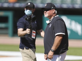 Mask were common on Friday at Comerca Park as the Detroit Tigers held the team's first workout as manager Ron Gardenhire, right, looks on.