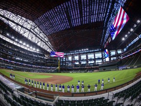 A view of the field and the players during the playing of the National Anthem before the game between the Texas Rangers and the Colorado Rockies at Globe Life Field.