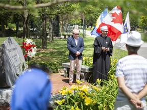 Emir Ramic, left, from the Institute for the Research of Genocide Canada, and Imam Adnan Balihodzic, lead a service at Jackson Park, Saturday, July 11, 2020, to mark the 25th anniversary of the Srebrenica massacre.