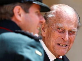 Britain's Prince Philip speaks to Assistant Colonel Commandant, Major General Tom Copinger-Symes during the transfer of the Colonel-in-Chief of the Rifles at Windsor Castle in Britain July 22, 2020.