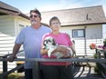 Eileen and Dan Steed, with one of their two dogs, Dot, are pictured outside their home in Essex, Saturday, July 4, 2020.