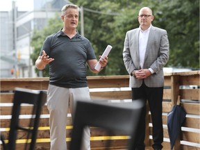 In this file photo from July 2020, Downtown Windsor Business Improvement Association chairman Brian Yeomans, left, and Mayor Drew Dilkens took part in the unveiling of a "Pitt Street Parklet" in downtown Windsor that offered outdoor seating for patrons of three neighbouring restaurants.