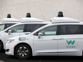 FILE PHOTO: Three of the fleet of 600 Waymo Chrysler Pacifica Hybrid self-driving vehicles are parked and displayed during a demonstration in Chandler, Arizona, November 29, 2018. Picture taken November 29, 2018.