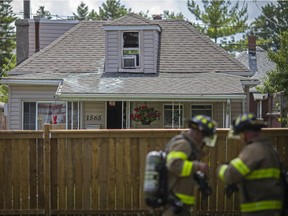 Fire crews work at the scene of a house fire in the 1500 block of Gladstone Avenue, Saturday, July 11, 2020.