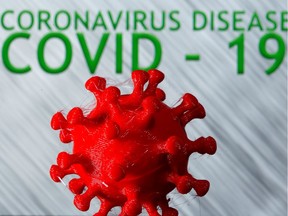 A 3D-printed coronavirus model is seen in front of the words coronavirus disease (COVID-19) on display in this illustration taken March 25, 2020.