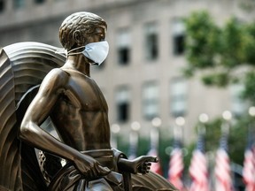 The Mankind Figure of Youth statue at Rockefeller Center in Manhattan is seen adorned with a face mask following the outbreak of the coronavirus disease (COVID-19), in New York City, New York, U.S., July 5, 2020.