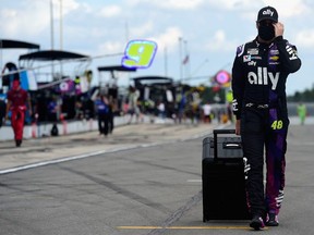 Jimmie Johnson walks on the grid prior to the NASCAR Cup Series Pocono 350 at Pocono Raceway on June 28, 2020 in Long Pond, Pennsylvania.