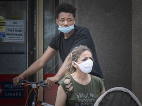Pedestrians in downtown Windsor wear masks to prevent the spread of COVID-19, Thursday, July 23, 2020.