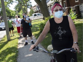 Cathy Short, right, joined nearly a dozen other residents on Saturday, July 4, 2020, as they marched along a street, warning neighbours that a convicted rapist lives on their block.