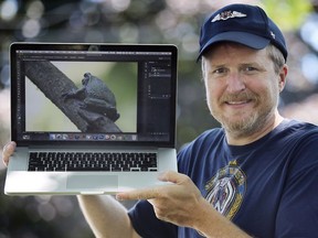 Mike Evans displays a photo on Tuesday, June 30, 2020 of a rare gray tree frog that he photographed in a South Windsor sanctuary recently.