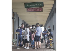 WINDSOR, ON. JULY 10, 2020 - A very long line up people wait to do business at the Service Ontario office on Dougall Ave. in Windsor, ON. on Friday, July 10, 2020. The service recently opened after being shut down for weeks during the pandemic. (Dan Janisse-The Windsor Star)