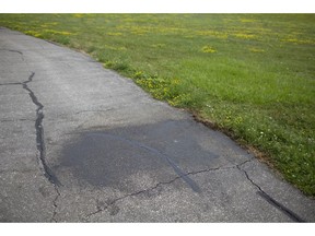 A black mark on a walking path in Lakeshore covers a racial slur, Wednesday, July 8, 2020.