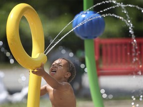 Jayden Fecteau, 3, cools down at the Realtor Park splash pad on Wednesday, July 15, 2020.