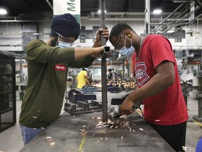 Back to school. St. Clair College industrial millwright students Karanjot Singh and Satinder Singh work on a lab project at the Ford Centre for Excellence on Monday, July 27, 2020.
