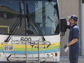 A Transit Windsor driver sanitizes a bus at the downtown station on July 9, 2020.