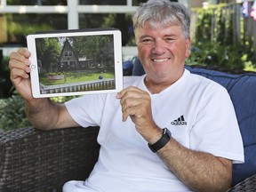 Ron Hebert displays a photo of the cottage he owns in Michigan on Monday, July 6, 2020 at his Tecumseh, ON. home. He has been unable to go over with the pandemic-related border shutdown.