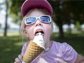 It's gonna be hot, hot, hot! Kirra Drayton, 4, gets to work on her ice cream cone while trying to beat the heat at Reaume Park with her parents on Friday, July 3, 2020.