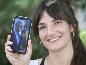Lauren Pickrell displays a cell phone photo of she and her new husband Mark Maksymiuk on Wednesday, July 8, 2020, in Tecumseh, ON. The two were married via a FaceTime call because the closed U.S./Canada border wouldn't allow them to physically get together.