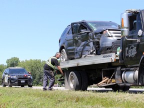 Towing operator with Sam's Towing and Recovery uses a flatbed truck to haul away a Ford Explorer SUV following a collision with a dump truck on Highway 3 near the Cameron Side Road. There were no injuries and OPP were at the scene investigating.