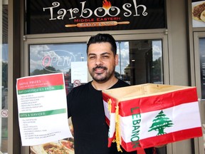 Over 20 Windsor and Essex County restaurants and businesses, including Tarboosh Middle Eastern Bakery and Grill, donating Wednesday proceeds to Red Cross for assistance to people of Lebanon following Aug. 4 blast at Beirut port. Here, restaurant owner Mouhamad Mouhadli who has family in Beirut, displays the raffle drop box at this South Windsor business.