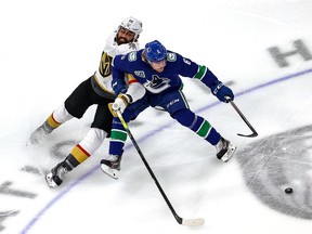 Brock Boeser and Alex Tuch #89 of the Vegas Golden Knights battle for the puck during the first period in Game Four.