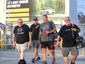 Autoworkers Adam Simon, left, John Deluca, right, and other workers leave FCA's Windsor Assembly Plant following the 3rd shift at 7 a.m. on July 10, 2020. Despite the end of the 3rd shift in the midst of a COVID-19 pandemic, automotive industry observers are cautiously optimistic about the sector's near future.