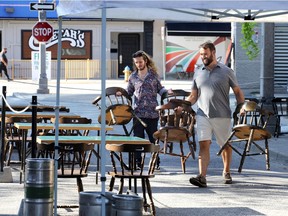 Weekend preparations. Corey Basden, left, and Geoff Zanetti add seating to the patio of Villains Beastro on Pelissier Street on Friday, Aug. 7, 2020. The Downtown Windsor Business Improvement Association is hosting another open streets weekend. Area businesses are allowed to expand into the sidewalks and streets.