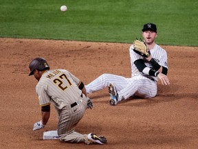 Colorado Rockies shortstop Trevor Story throws the ball over San Diego Padres catcher Francisco Mejia to first for an out in the seventh inning at Coors Field.