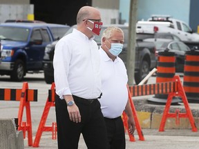 Windsor Mayor Drew Dilkens, left, and Premier Doug Ford are shown at the City of Windsor public works yard on Crawford Avenue on Thursday, August 13, 2020 where a COVID-19-centred news conference was held.