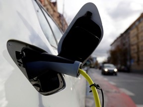 FILE PHOTO: An electric car is charged by a mobile charging station on a street in Prague, Czech Republic, December 4, 2018. Picture taken December 4, 2018.