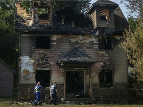 Investigators work at the scene of a destructive house fire on the 2000 block of Lansing Street, Thursday, Aug. 27, 2020.