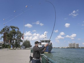 Clayton Phelps cast his fishing line into the Detroit river in downtown Windsor on Friday, August 7, 2020.