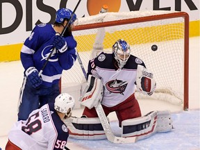 Columbus Blue Jackets goaltender Joonas Korpisalo (70) makes a save behind Tampa Bay Lightning left wing Pat Maroon (14) during the third period in game two of the first round of the 2020 Stanley Cup Playoffs at Scotiabank Arena on Aug. 13, 2020.