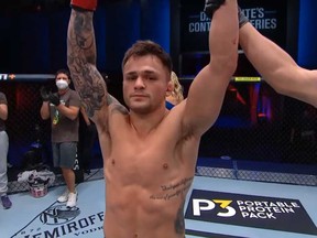 Windsor MMA fighter raises his arms in victory after winning his featherweight bout in Dana White's Tuesday Night Contender Series at the UFC Apex venue on Aug. 11, 2020. The win has earned Laramie his first UFC contract.