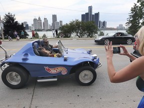 WINDSOR, ON. AUGUST 14, 2020 -  A woman snaps a photo of a dune buggy during the Ouellette Car Cruise on Friday, August 14, 2020 in downtown Windsor, ON. (DAN JANISSE - The Windsor Star)