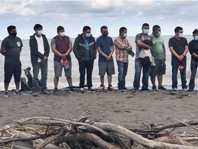 Migrant workers gather on a beach at Wheatley Provincial Park on Aug. 16, 2020, to honour Santos Cuc Diaz, 28, of Guatemala, who drowned in the waters of Lake Erie on July 12, 2020.